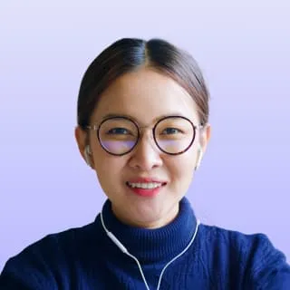 a woman wearing glasses and listening to music