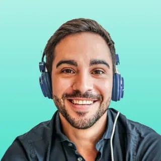 a man with headphones on smiling at the camera